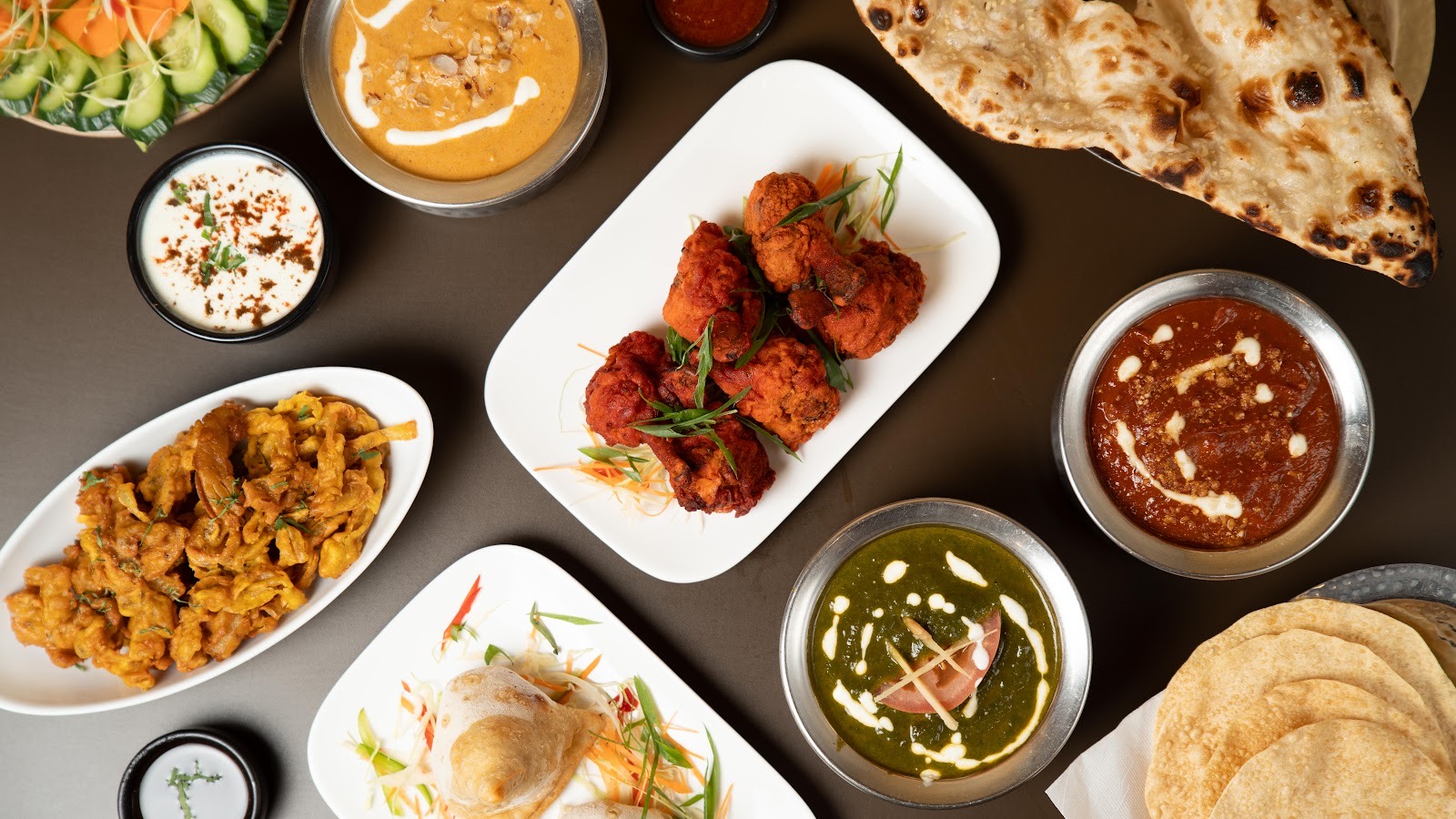 A spread of curries, breads, pakora and chicken tikka